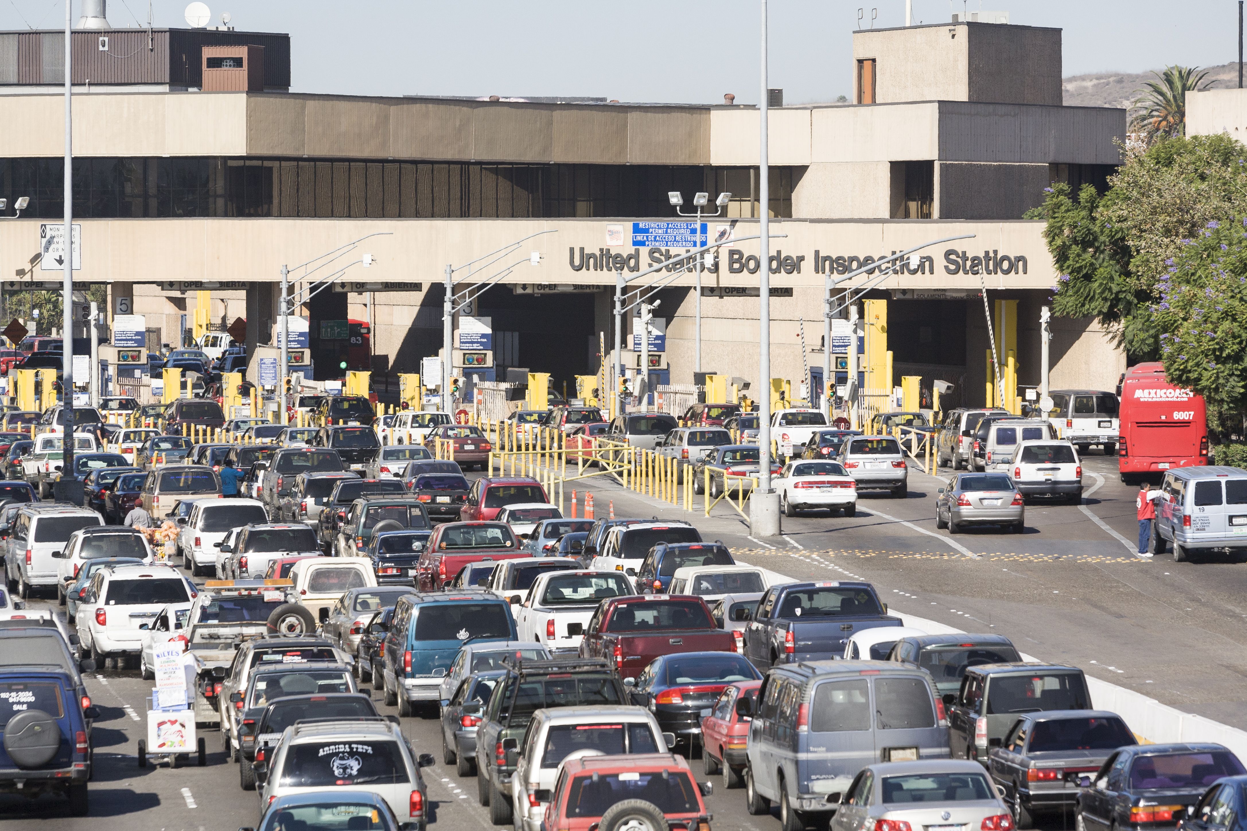 Vehicles lined up for US immigration and customs processing at the border entry point from Tijuana, Mexico to San Ysidro, California, USA