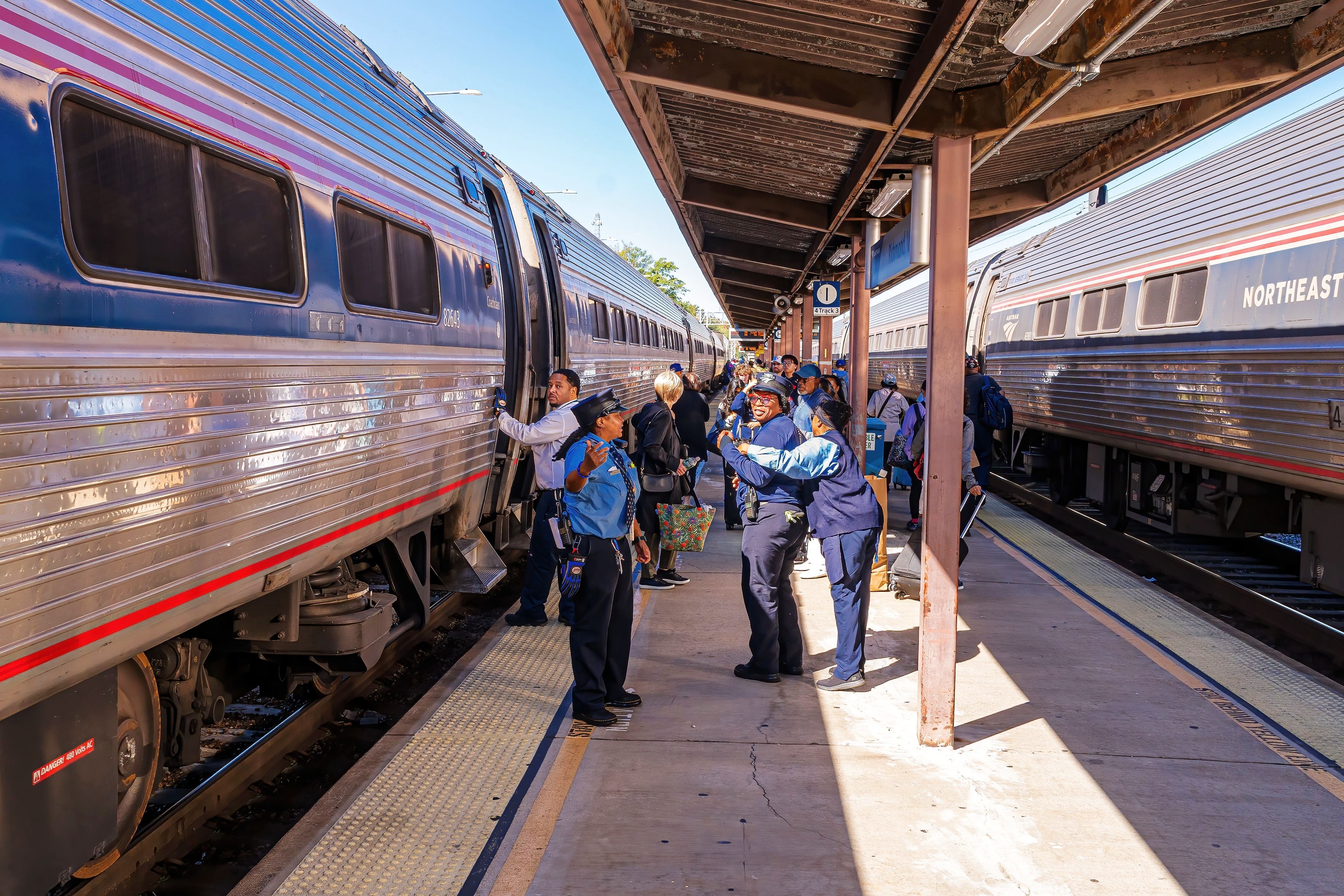 Amtrak Conductors Have a Friendly Conversation While Waiting for Passengers