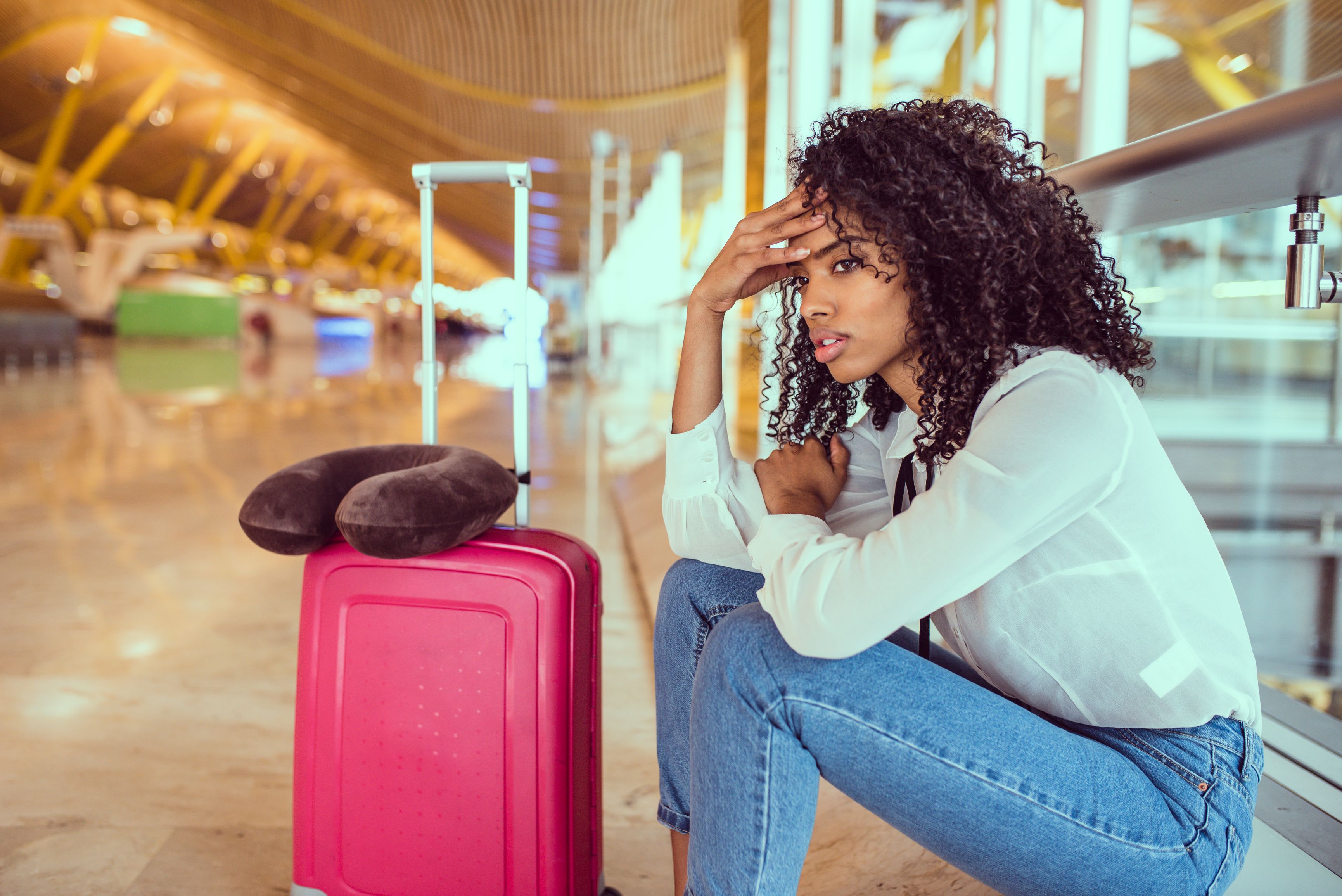 Woman upset and frustrated at the airport with flight canceled