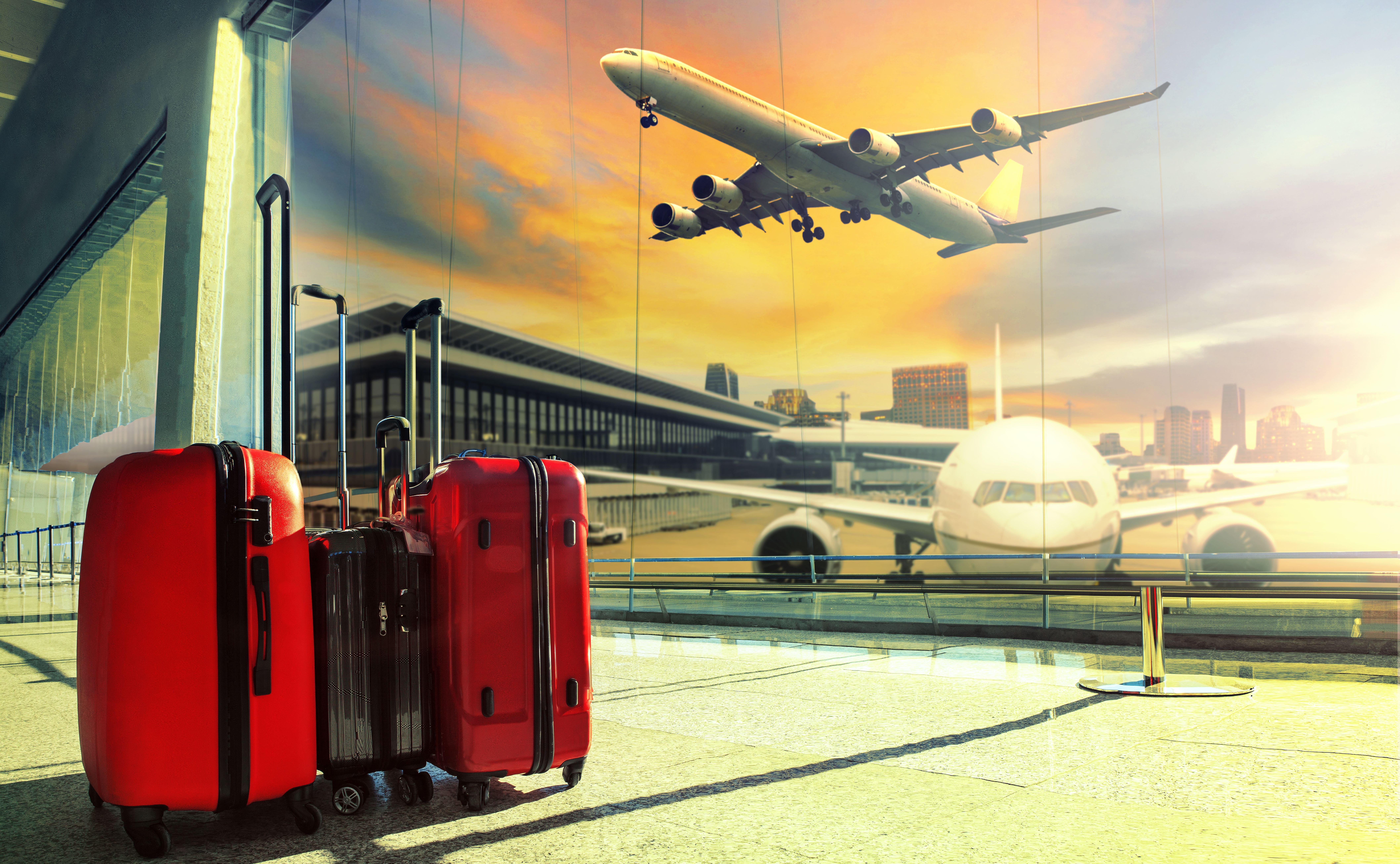 Traveling luggage in airport terminal building and jet plane flying over urban scene68