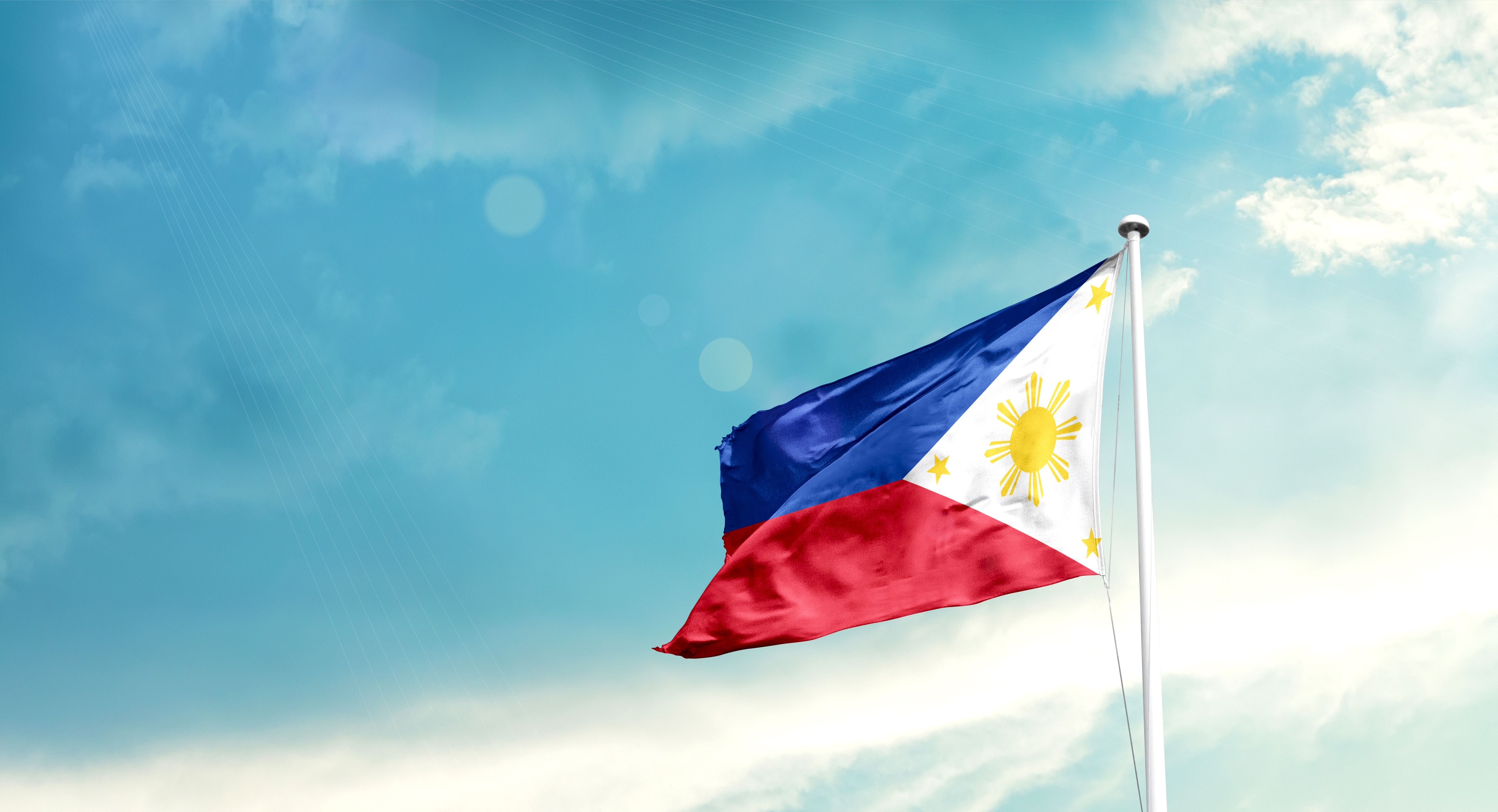 Philippines national flag fluttering. The flag blowing in beautiful soft sky. Philippines national flag for independence day.