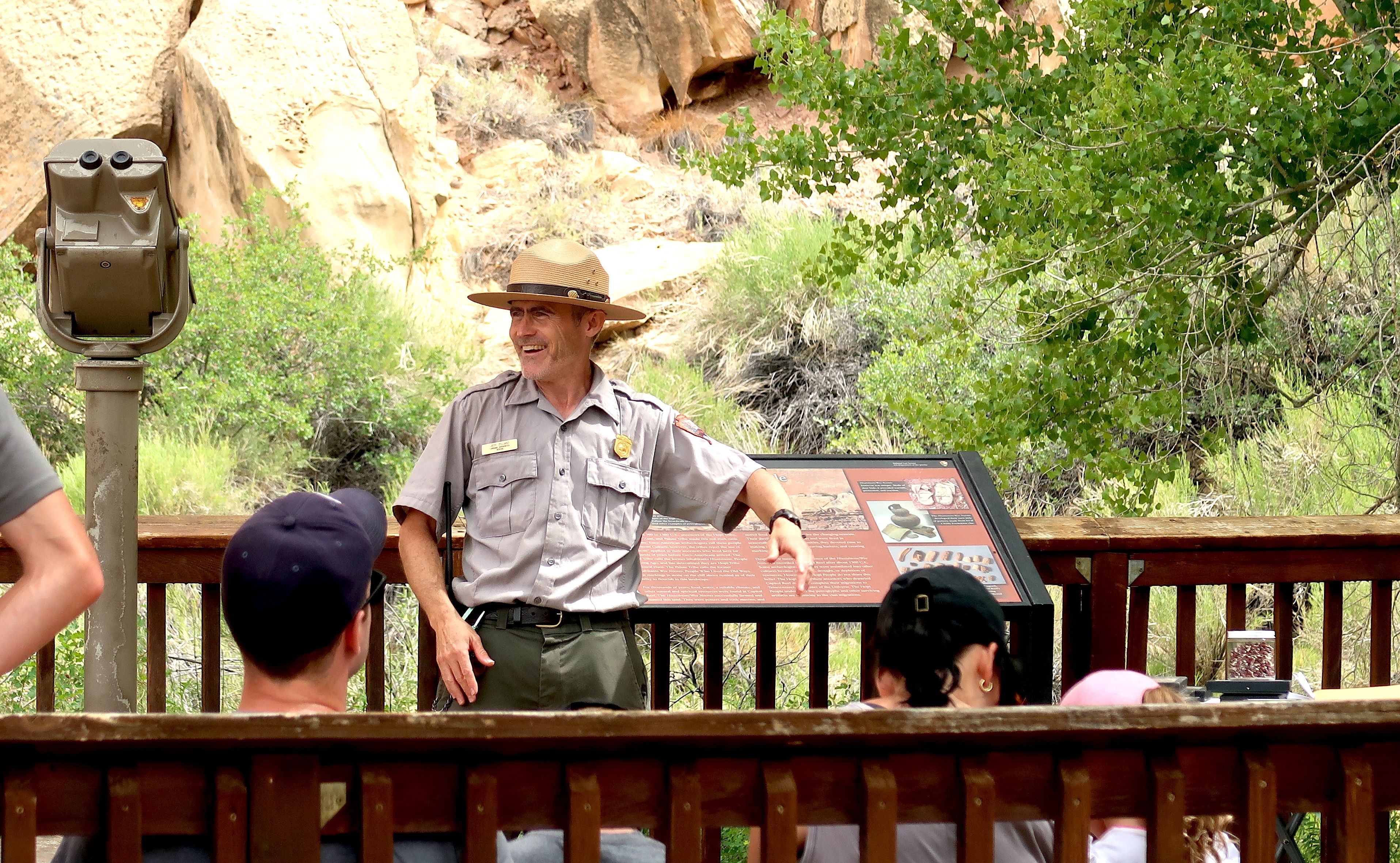 Visitors see Petroglyphs of ancient Fremont culture with NPS Ranger at Capitol Reef National Park, Utah, USA