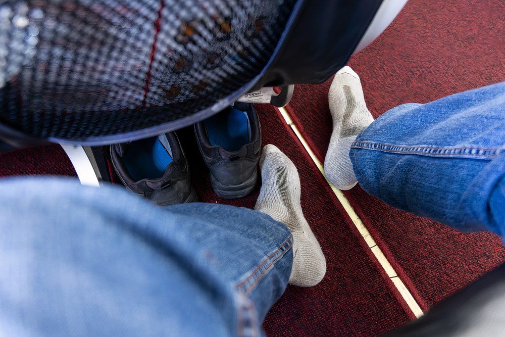 A passenger removed his shoes in the cabin to relax his feet during a long-haul flight