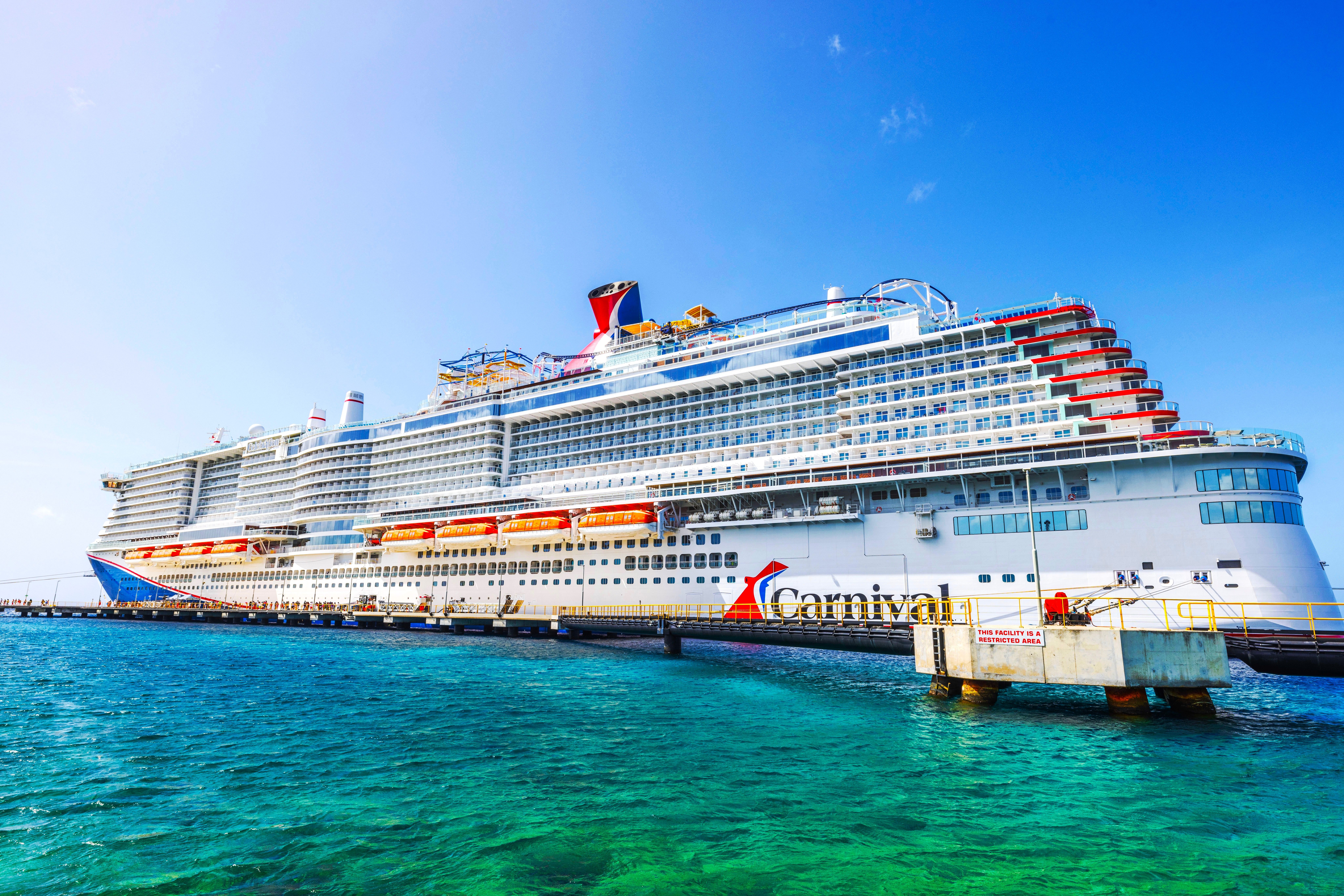 A Carnival Cruise Line cruise ship in the Caribbean docked at a port