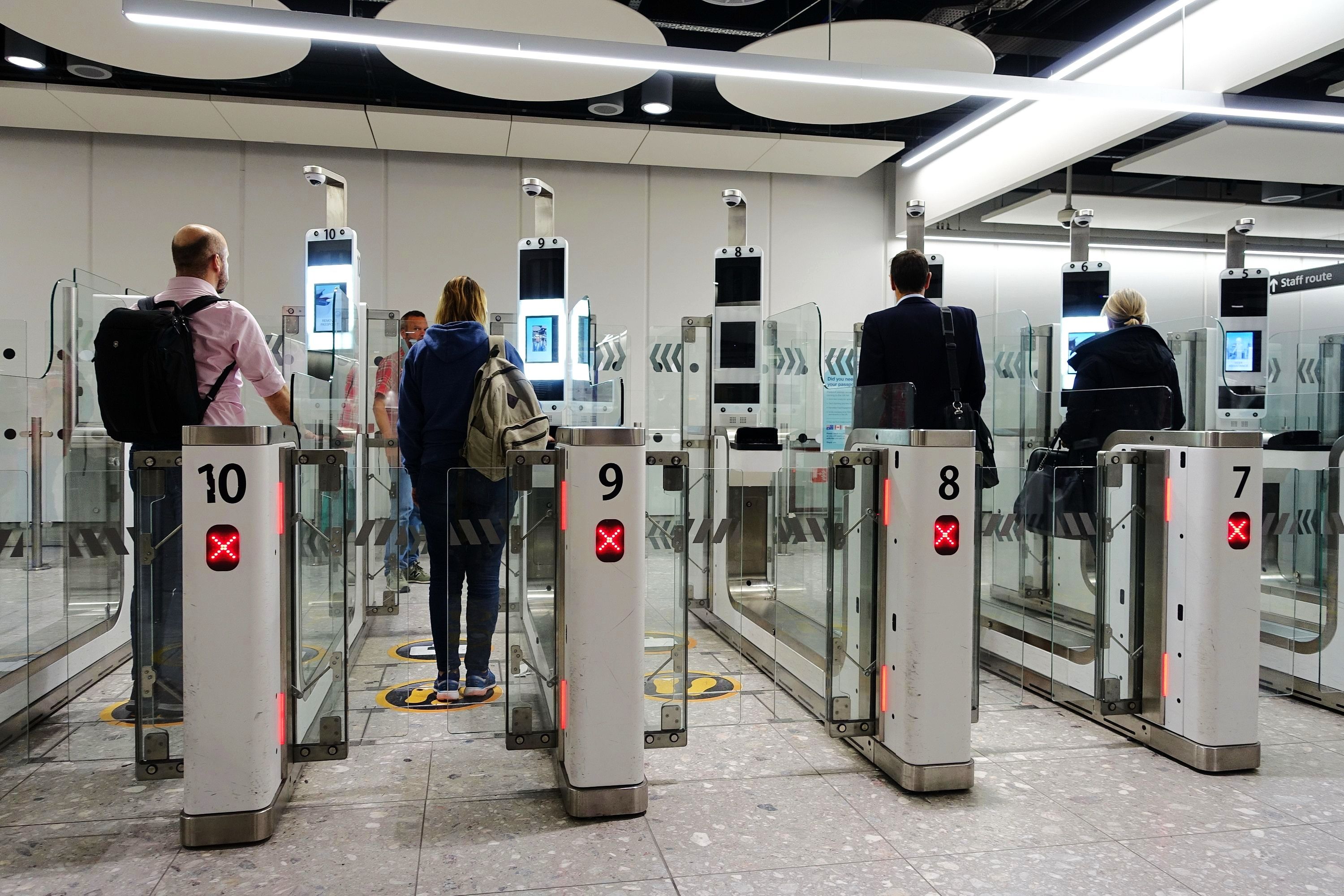 Air travellers pass through automated passport border control e-gates at Heathrow Airport. Heathrow and Britain's Border Force use facial recognition technology
