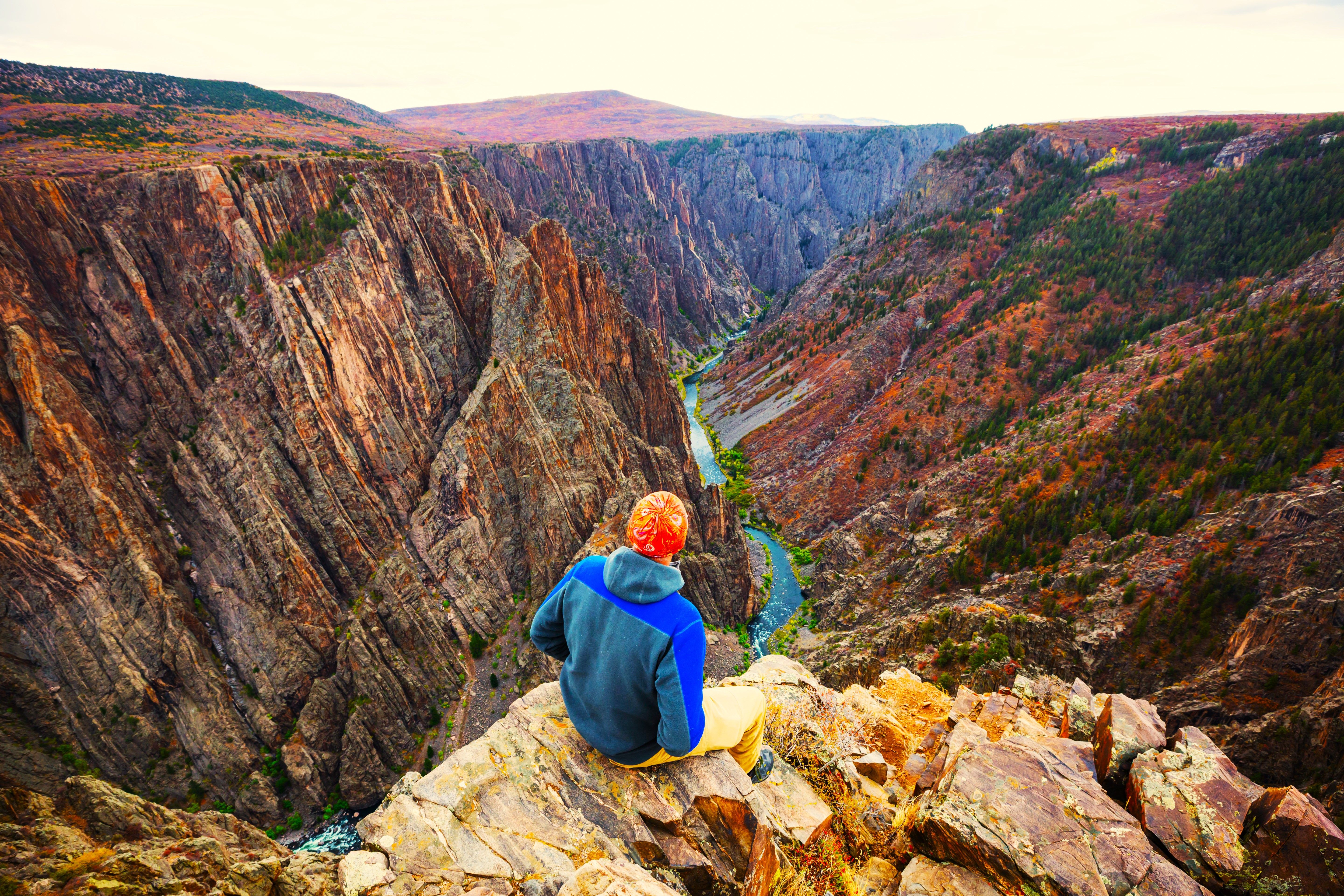 Tourist on the granite cliffs at Black Canyon of the Gunnison National Park, Colorado, USA