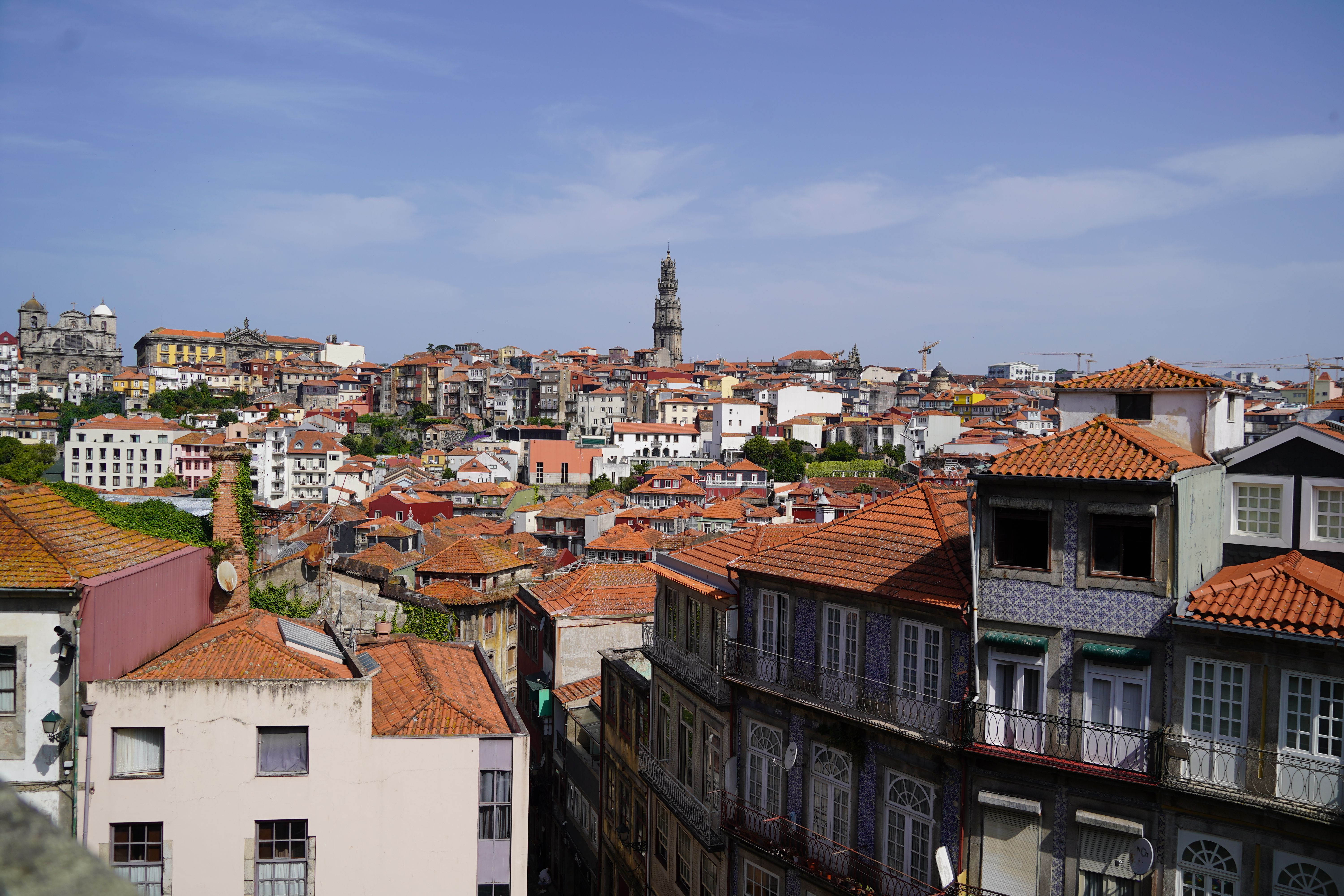 View of the city of Porto, in Portugal, with rooftops and a church spire in the distance