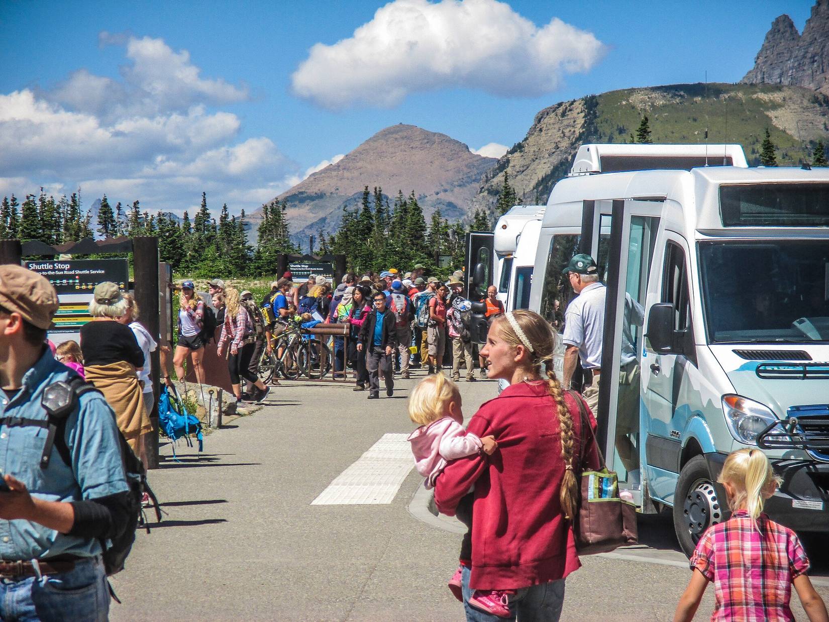 Crowds at the busy Logan Pass shuttle stop in Glacier National Park, Montana, MT, USA