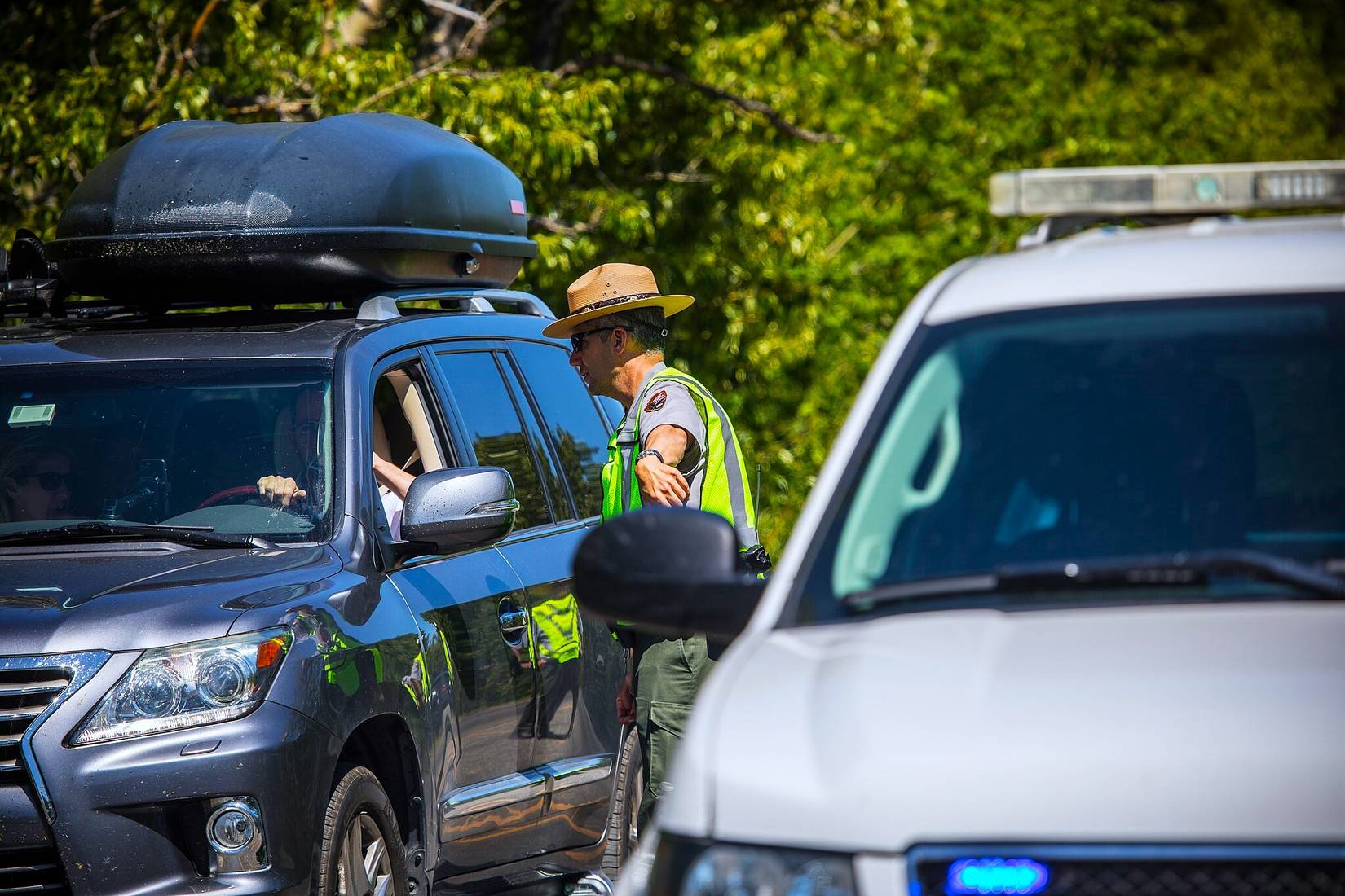 NPS ranger enforcing Many Glacier area traffic restrictions in Glacier National Park, Montana, MT, USA