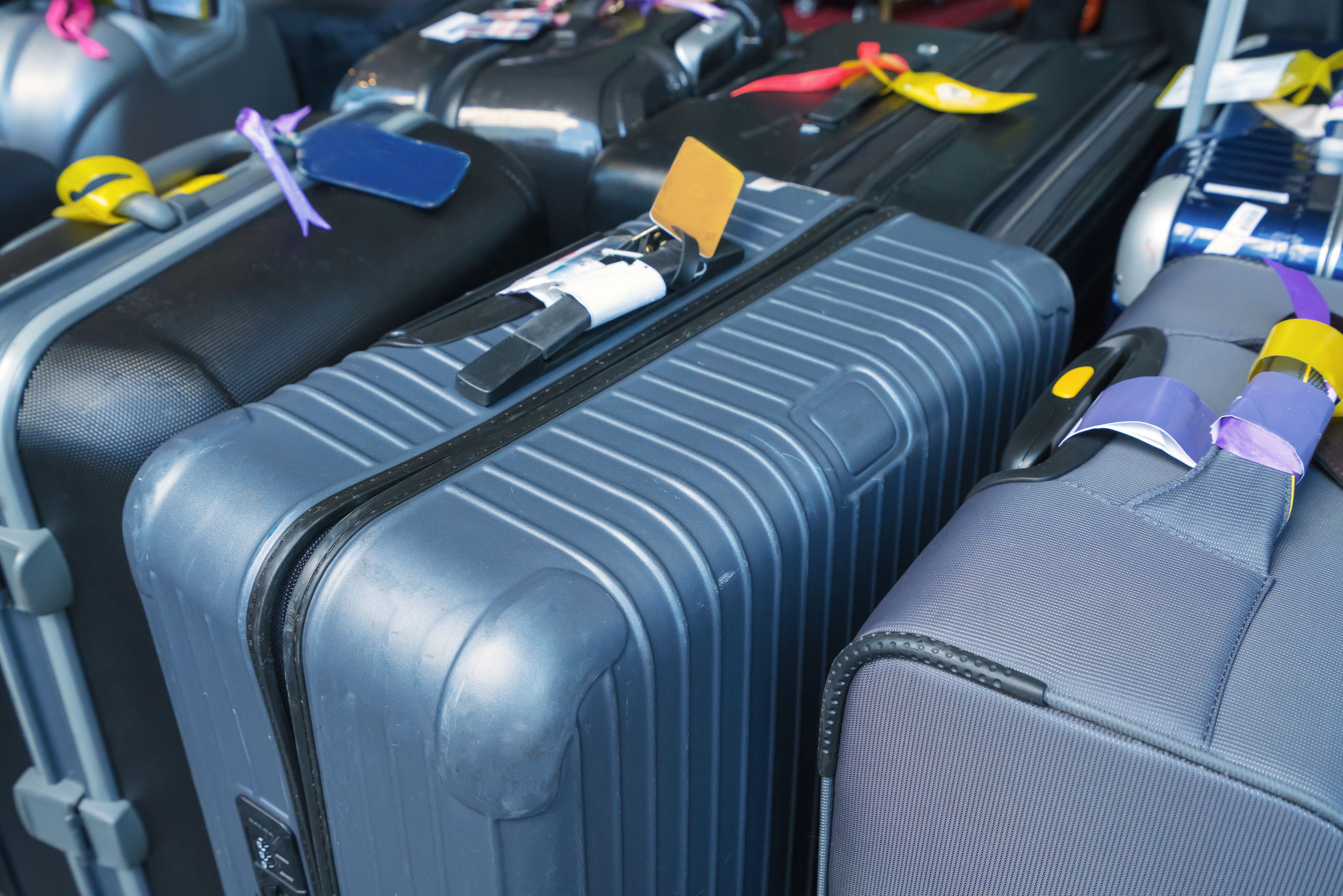 Large suitcases with tags attached to them.