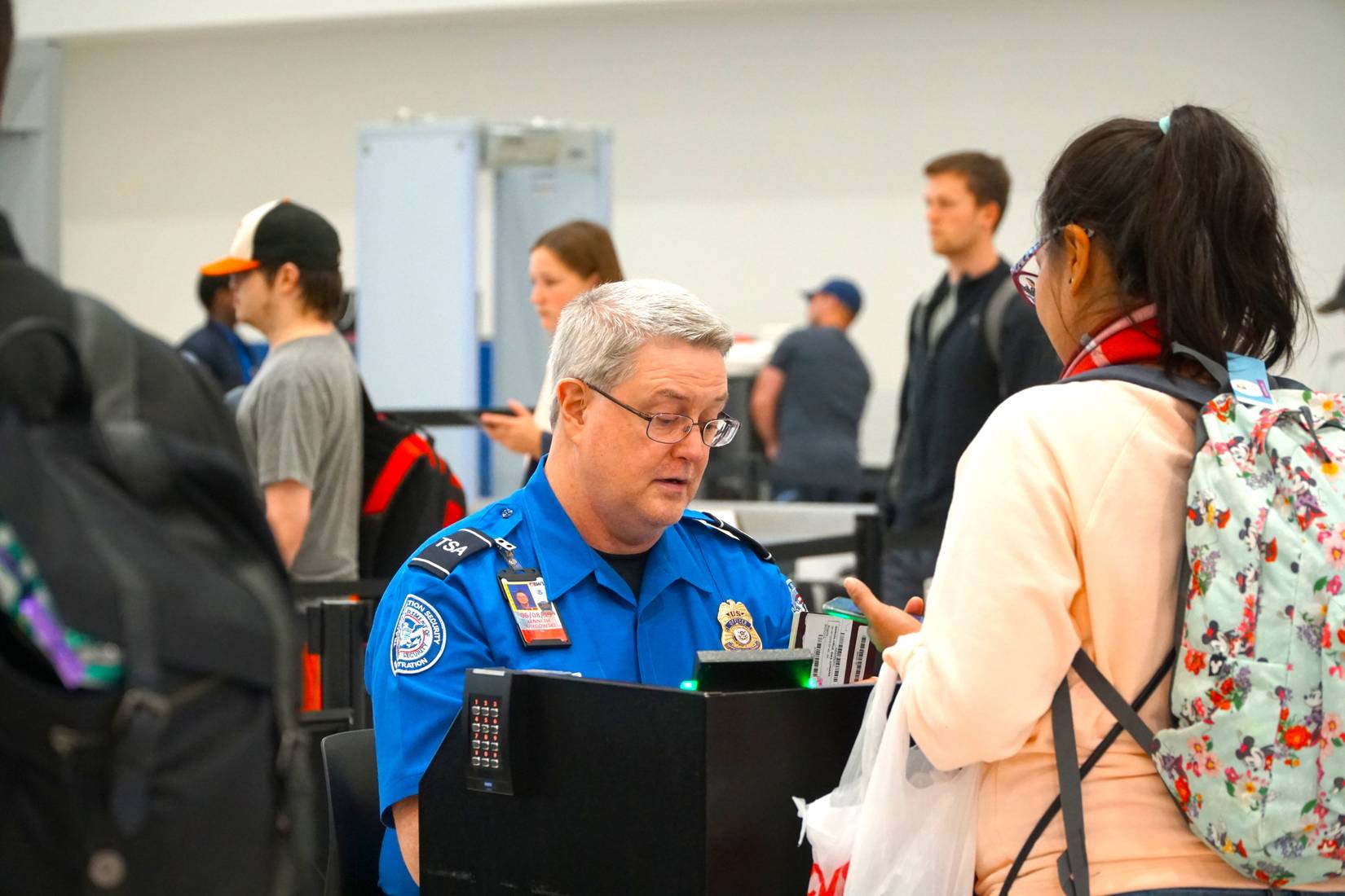 TSA (Transportation Security Administration) worker checks a passport at the BWI airport, Baltimore, Maryland.
