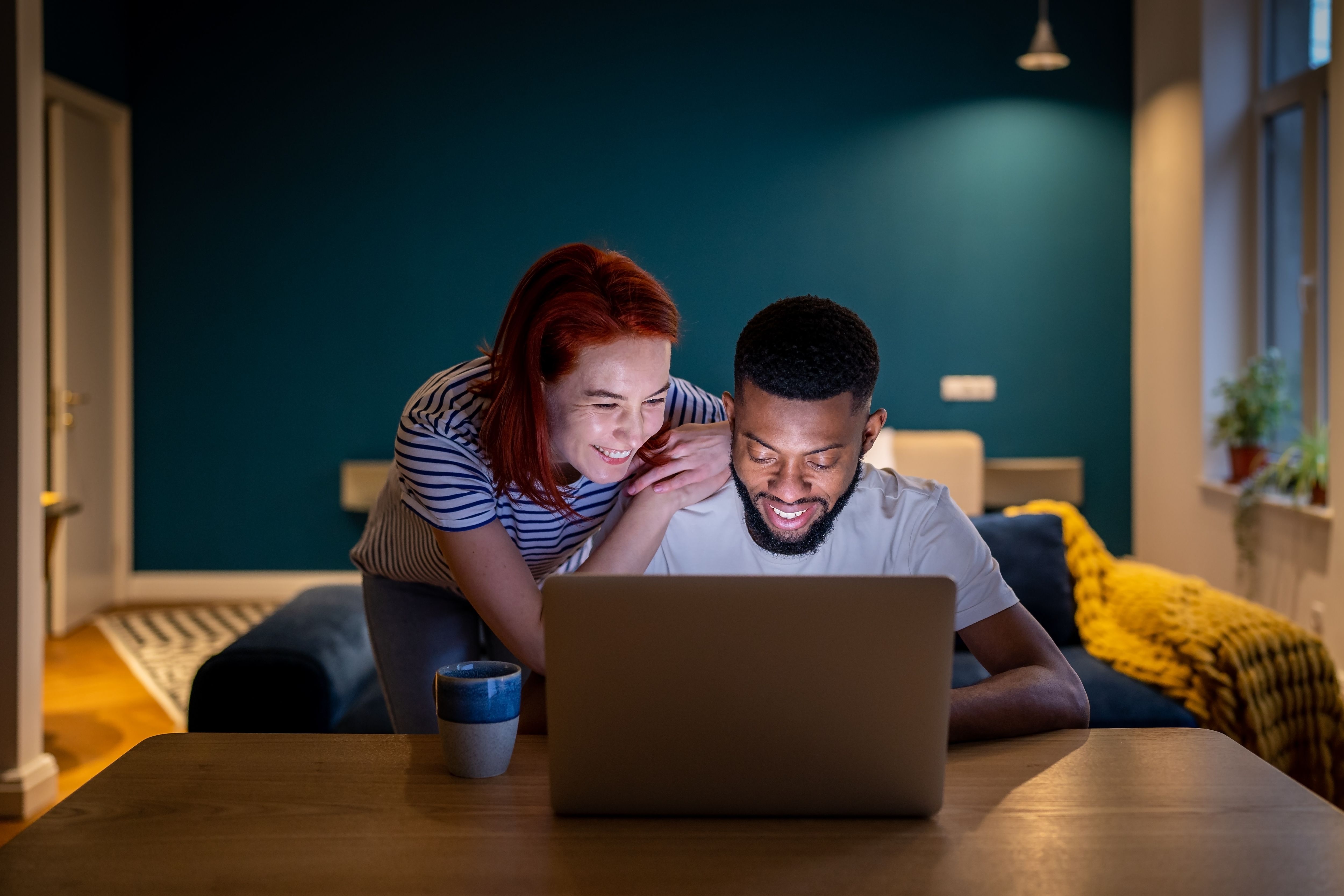 A man and woman booking flight tickets on a laptop.