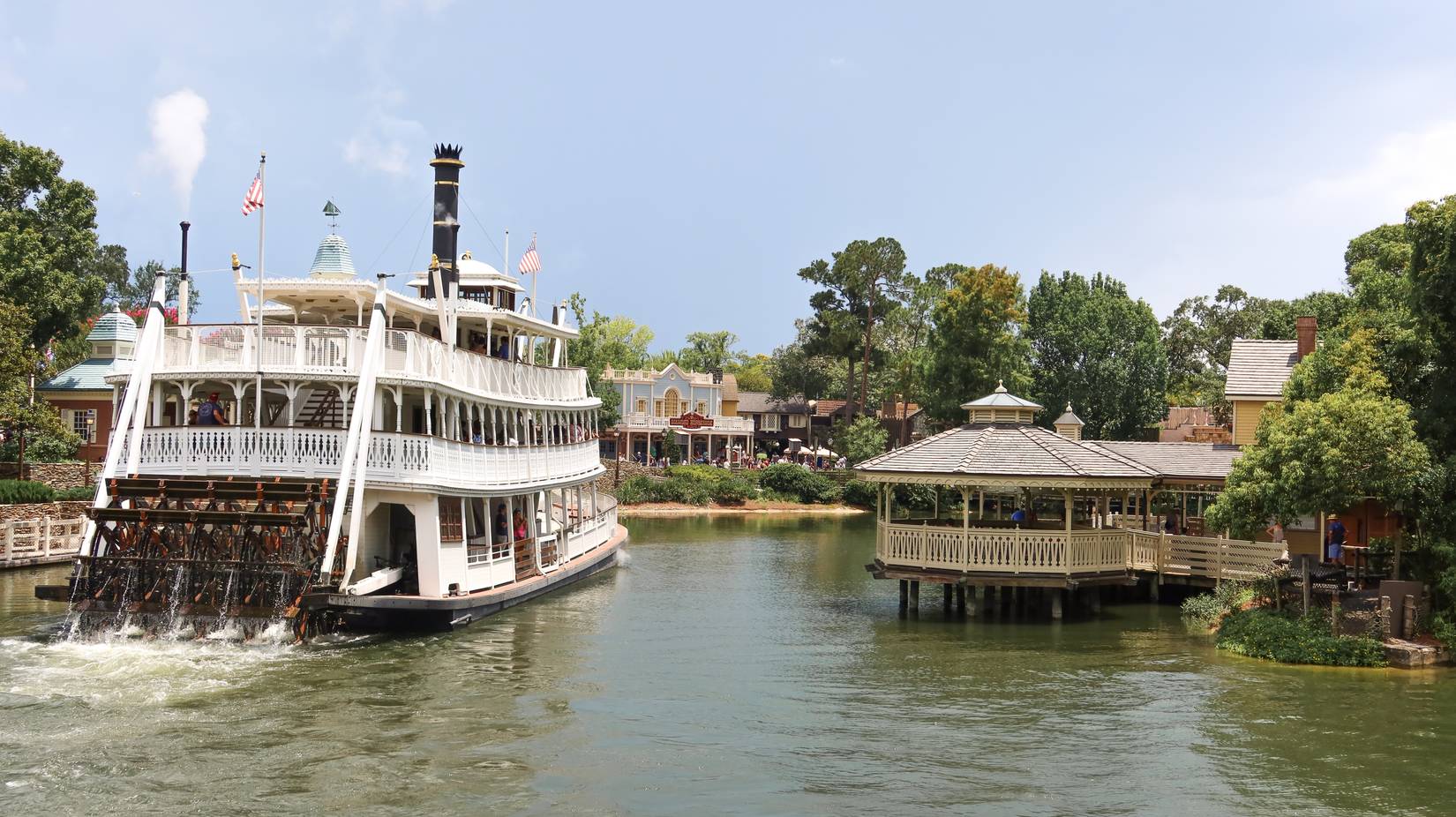 The Liberty Square Riverboat churns past the waterfront gazebo at Disney's Magic Kingdom in Florida.